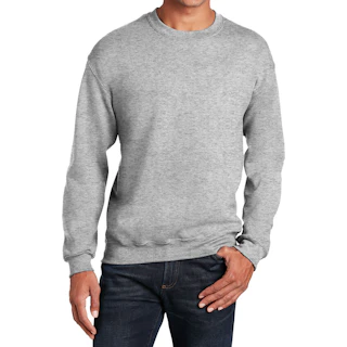 A man standing and wearing a solid gray crewneck sweatshirt with dark wash jeans.