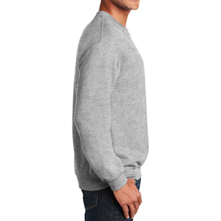 A man standing in profile and wearing a solid grey sweatshirt with his thumb in his jeans pocket.
