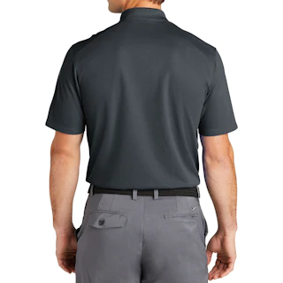 The back of a man standing and wearing a dark gray Nike polo shirt with light gray pants.