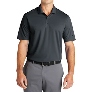 A man wearing a solid dark gray Nike polo shirt with light gray pants and a black belt.