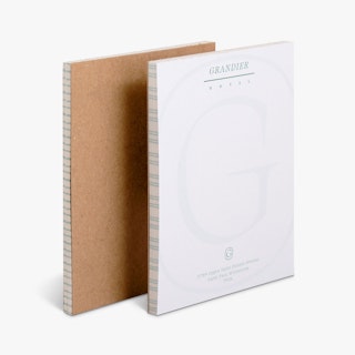 Two custom notepads overlapping each other with Grandier Hotel in green at the top and a cardboard back.