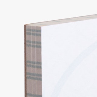 The corner of a custom notepad printed with white pages, a cardboard backing and green lines on the sides.