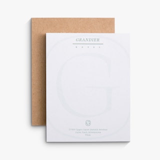 Two branded notepads overlapping each other with Grandier Hotel in green at the top.