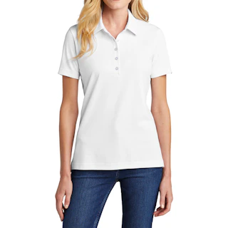 A woman in a solid white company polo with dark jeans.