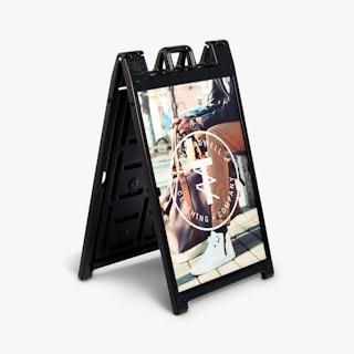 An A-frame sidewalk sign with a black frame and a sign printed with Threadwell Clothing Company.