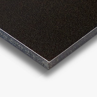 The corner of a custom aluminum sign printed with a solid black background and slim white trim.