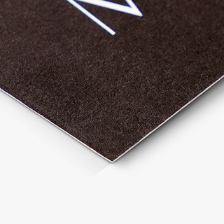 The bottom corner of a custom appointment card printed with a black background and white text.