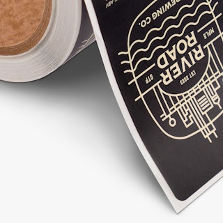 Roll labels printed with a black and white design and River Road Brewing Co. MPLS STP.
