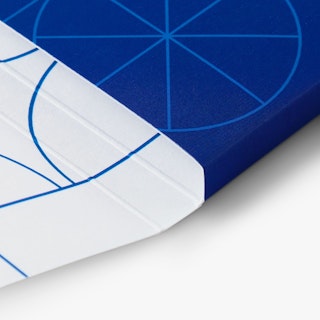 The corner of a branded folder custom printed in white and blue with geometric designs.