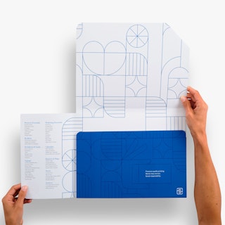 Two hands holding open the panels of a branded folder printed with a white and blue design.