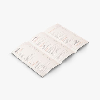 A brochure menu with three panels laying open to drink and breakfast item details.
