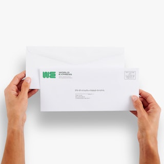 Two hands holding two business envelopes printed with World Express in green in the top left corner.