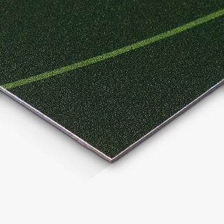 The corner of a vehicle magnet printed with a black background and a slim green stripe.