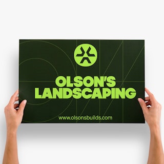 Two hands holding a car magnet custom printed with a black background and Olson's Landscaping.