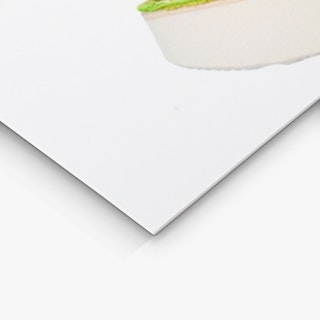 The bottom corner of a custom cardstock sign printed with a white background and white shoe sole.