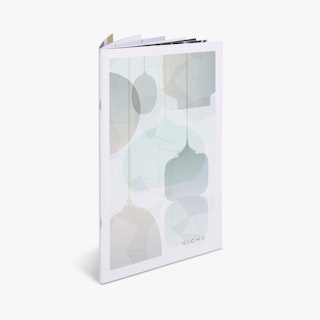 A custom product catalog standing open with an abstract graphic of lighting fixtures on the cover.