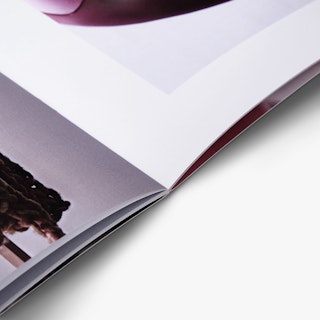 A custom catalog laying open with a saddle stitch binding and product images on the pages.