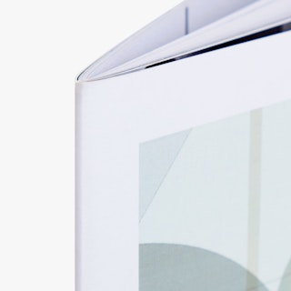 The top corner of a product catalog printed with a saddle stitch binding and a pale green cover design.