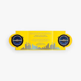 A gate fold brochure laying open with a yellow background and speaker design.