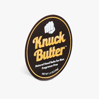A custom label printed with a round shape and Knuck Butter in yellow, white and black.