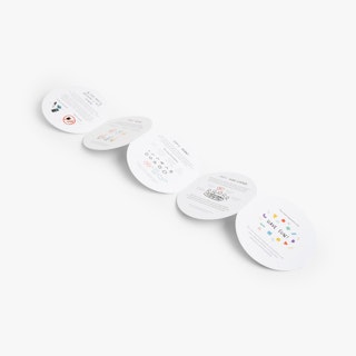 A circular accordion brochure laying unfolded with five panels printed with colorful graphics.