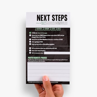 A hand holding a church connection card printed with Next Steps and a field for prayer requests.
