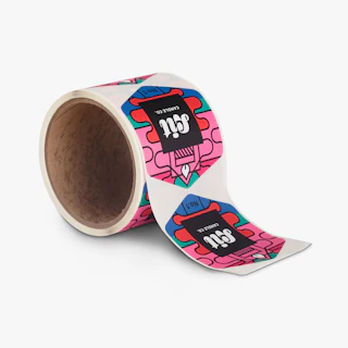 A roll of custom roll labels printed with pink, red, green and blue labels.
