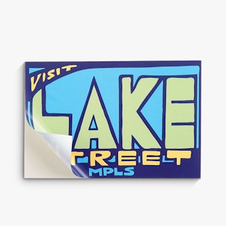 A custom decal with the bottom corner peeling of the backing and a blue, green and yellow design.