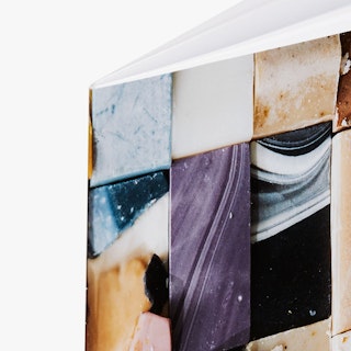 The top left corner of a custom catalog printed with a saddle stitch binding and images of soap bars.