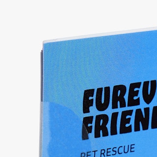 The corner of a newsletter printed with a blue background, Furever Friends in black and a wafer seal.