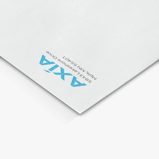 The top left corner of a custom envelope printed with AXIA in blue and an address.