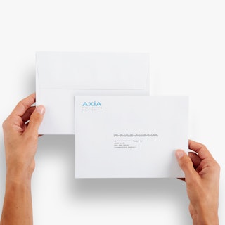 Two hands holding two envelopes printed with AXIA in blue in the top left corner and an address in the middle.
