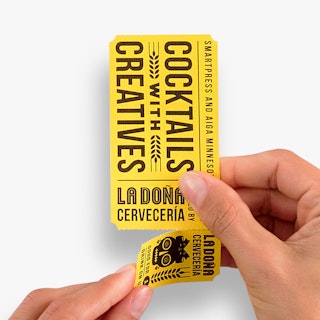 Two hands tearing off a drink ticket printed with Cocktails With Creatives in black and yellow.