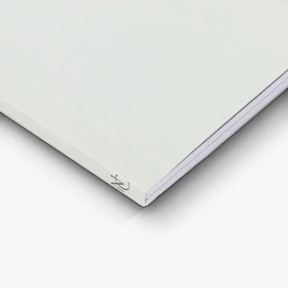 The bottom left corner of an investment guide printed with a white cover and NC on the spine.
