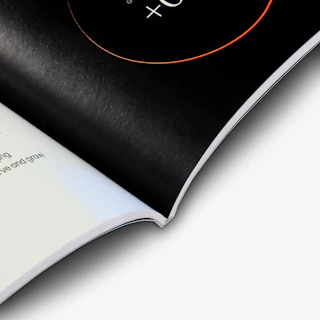 A guide to investment strategy book laying open to pages printed with a black and white design.