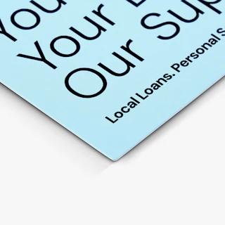 The bottom left corner of a custom postcard printed with loan details in light blue and black.