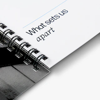 The spine of a wire bound fund deck printed with financial firm information.