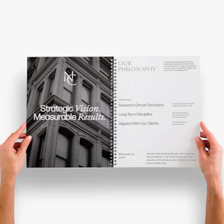 Two hands holding an investor pitch deck open to information about the firm's philosophy.
