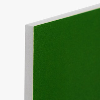 The top corner of a foam board sign printed with a dark green background and white edge.