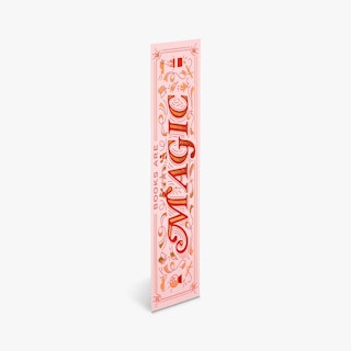 A custom bookmark printed with Books Are Magic in pink, red and gold foil.