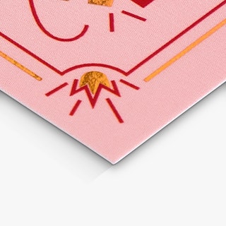 The corner of a custom bookmark printed in pink and red with gold foil accents.