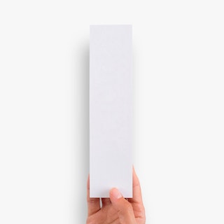 A hand holding a blank white bookmark.