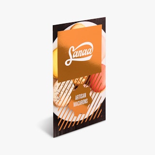 A flat card with no fold printed with rose gold foil and Sanaa Artisan Macarons on the front.