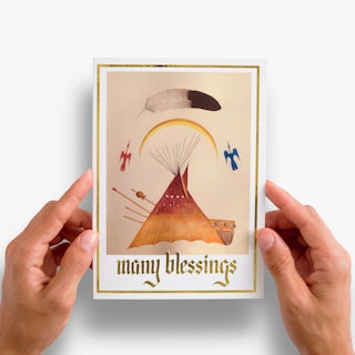 Two hands holding a custom greeting card printed with Many Blessings in gold foil and indigenous artwork.