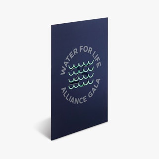 A foil invitation printed with a dark blue background, Water for Life Alliance Gala and blue-green foil accents.