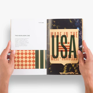 Two hands holding a catalog open to product information about the Heirloom Line.