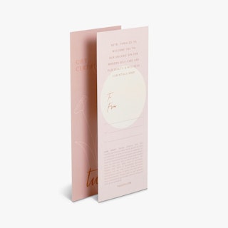 Two gift cards printed with a pink and cream design and spa information.