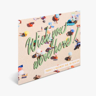A custom card printed with a beach scene and With You Were Here on the front.