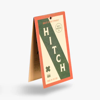 A custom hang tag printed with Hitch marketing in green, cream and orange.