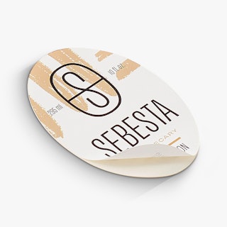 An oval beauty product label printed with a black and tan design and Sebesta Apothecary.